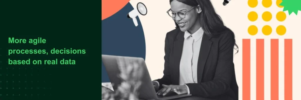 woman sitting in front of a computer wearing a business suit and smiling